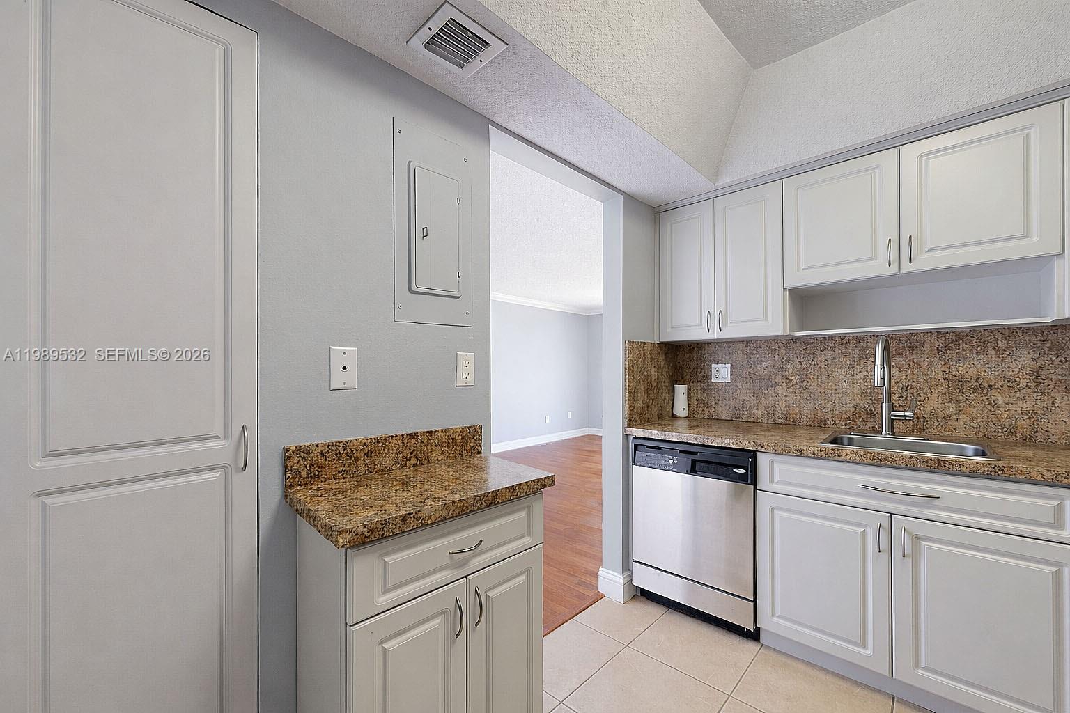 3581 Southwest 117th Avenue, Unit 5308 Miami, FL 33165 - Photo 17 of 38 a kitchen with white cabinets and sink