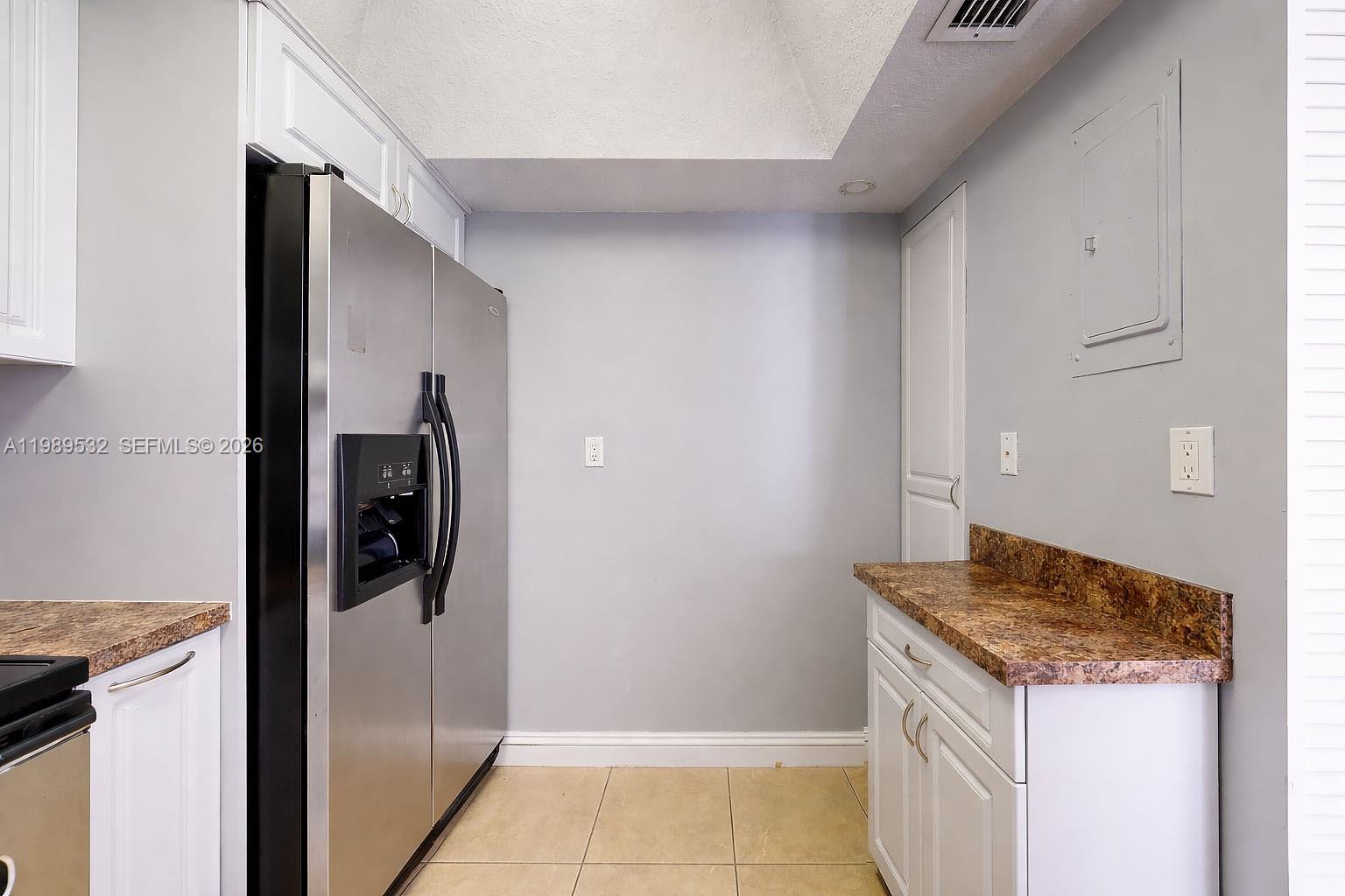 3581 Southwest 117th Avenue, Unit 5308 Miami, FL 33165 - Photo 19 of 38 a kitchen with a refrigerator and a stove
