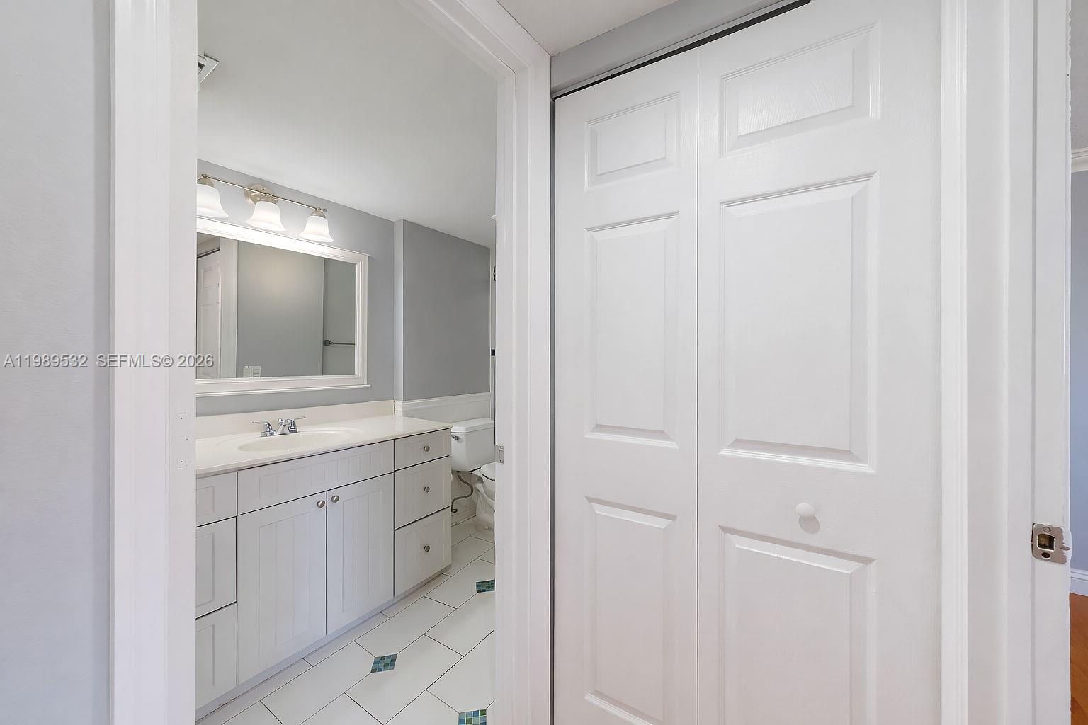 3581 Southwest 117th Avenue, Unit 5308 Miami, FL 33165 - Photo 21 of 38 a bathroom with a double vanity sink and mirror