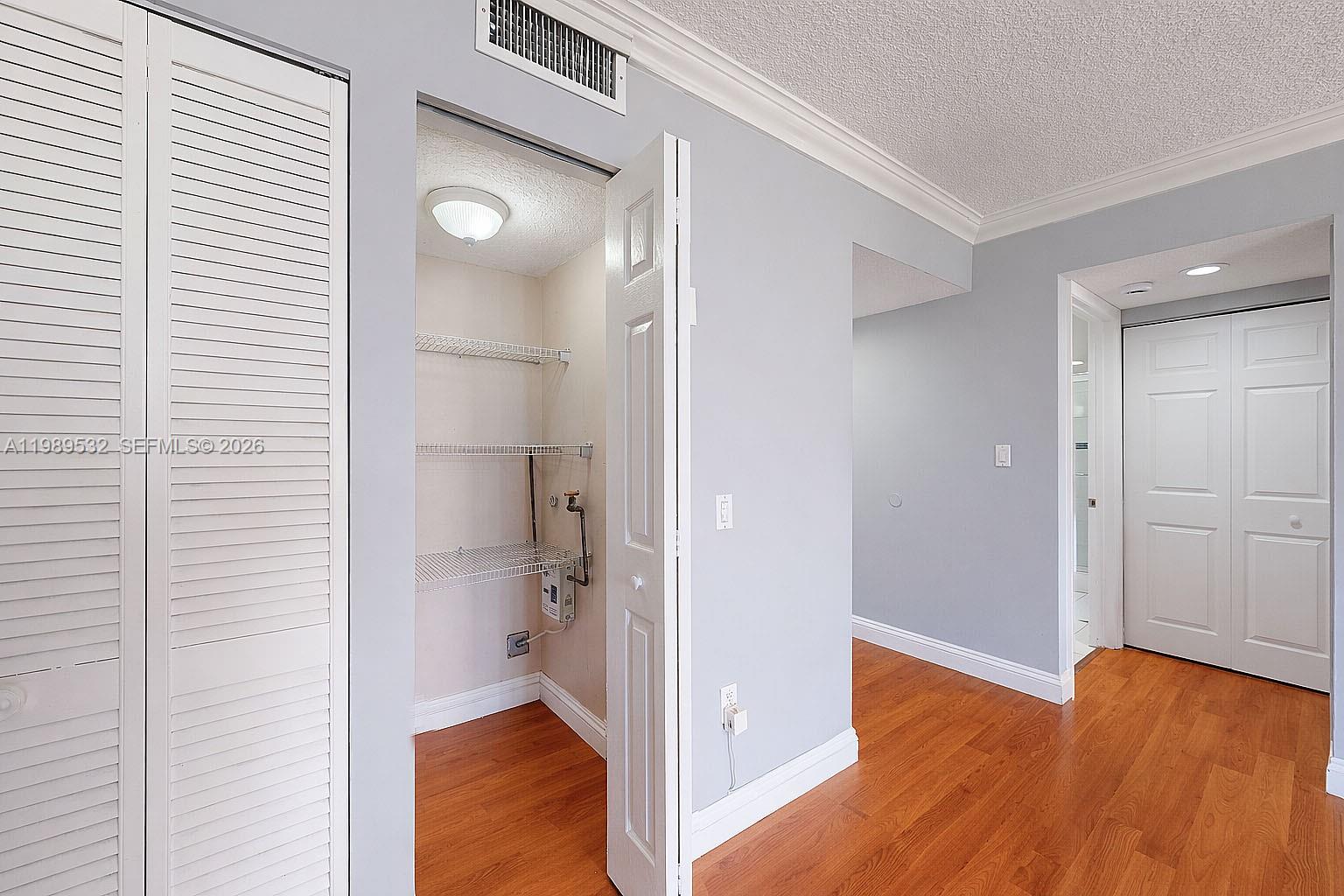 3581 Southwest 117th Avenue, Unit 5308 Miami, FL 33165 - Photo 23 of 38 a view of a room with wooden floor and a bathroom