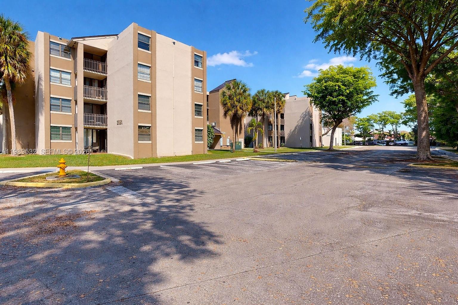 3581 Southwest 117th Avenue, Unit 5308 Miami, FL 33165 - Photo 3 of 38 a view of a building with a yard