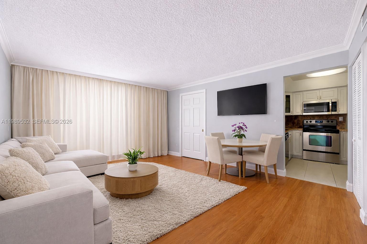 3581 Southwest 117th Avenue, Unit 5308 Miami, FL 33165 - Photo 8 of 38 a living room with furniture and a flat screen tv