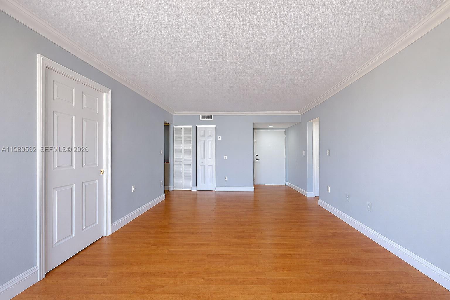 3581 Southwest 117th Avenue, Unit 5308 Miami, FL 33165 - Photo 9 of 38 a view of an empty room with wooden floor