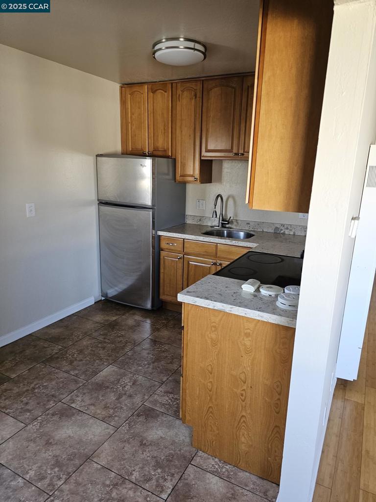 2287 Cuadra Court Pinole, CA 94564 - Photo 9 of 12 a kitchen with a refrigerator and a sink