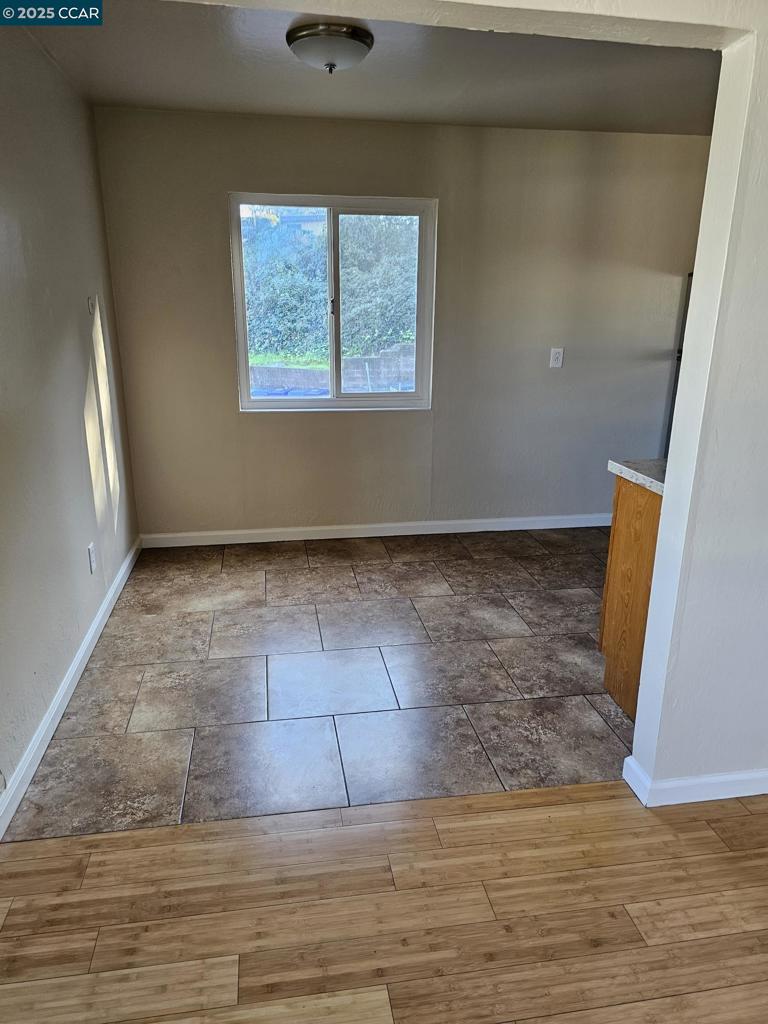 2287 Cuadra Court Pinole, CA 94564 - Photo 10 of 12 an empty room with wooden floor and windows