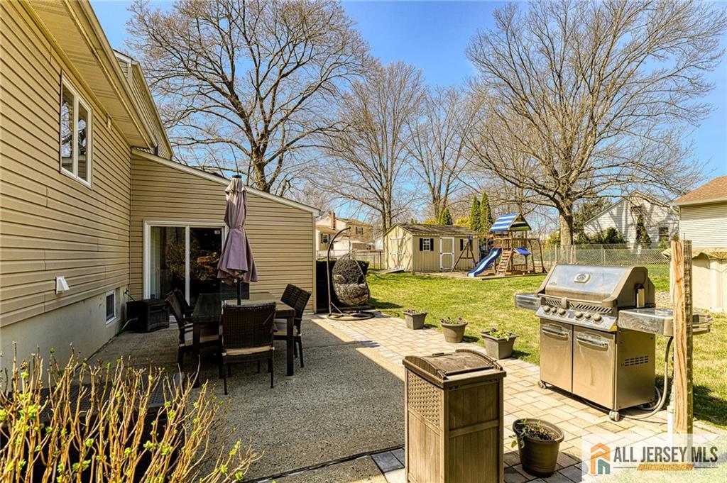 35 Outcalt Road Edison, NJ 08817 - Photo 31 of 33 a view of a patio with table and chairs and a barbeque