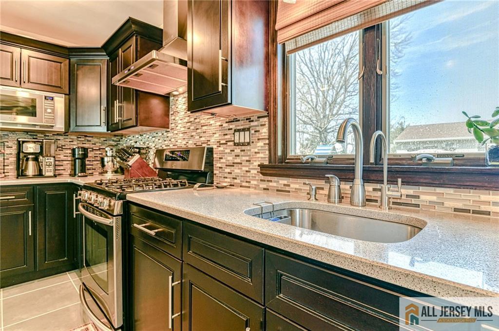 35 Outcalt Road Edison, NJ 08817 - Photo 6 of 33 a kitchen with stainless steel appliances a sink and a window