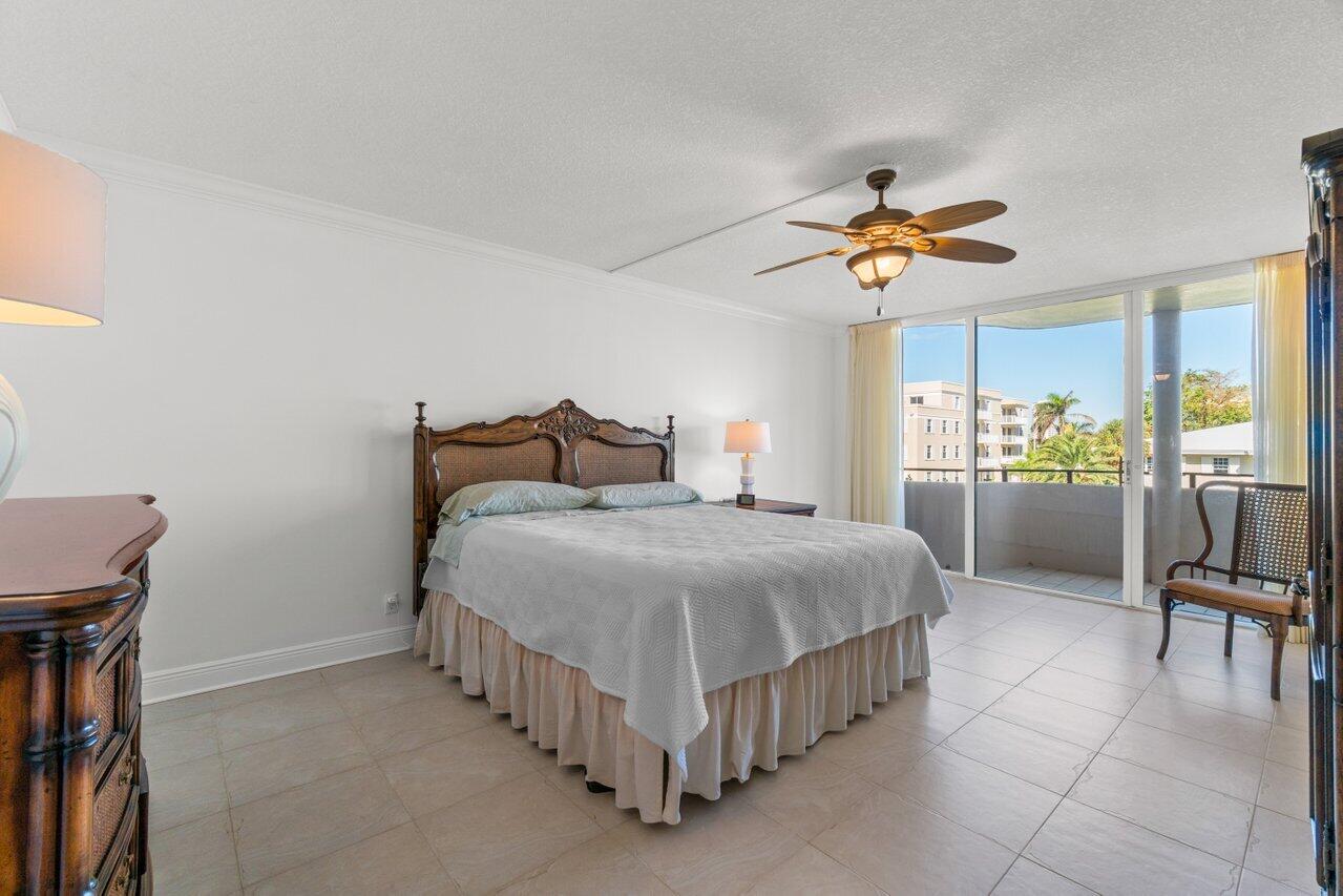 1401 South Ocean Boulevard, Unit 3090 Boca Raton, FL 33432 - Photo 11 of 46 a bedroom with a bed and a chandelier
