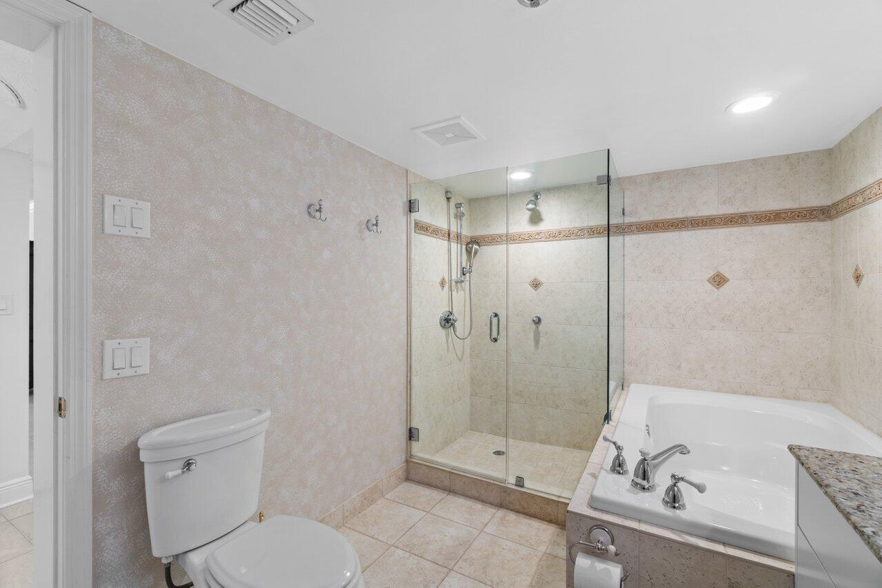 1401 South Ocean Boulevard, Unit 3090 Boca Raton, FL 33432 - Photo 14 of 46 a bathroom with a sink a toilet and shower