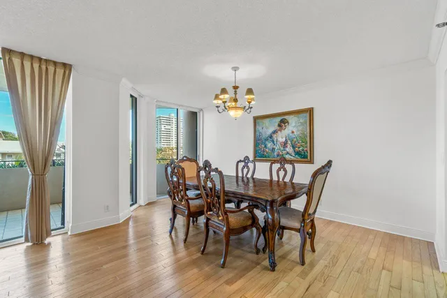 a view of a dining room with furniture wooden floor and chandelier