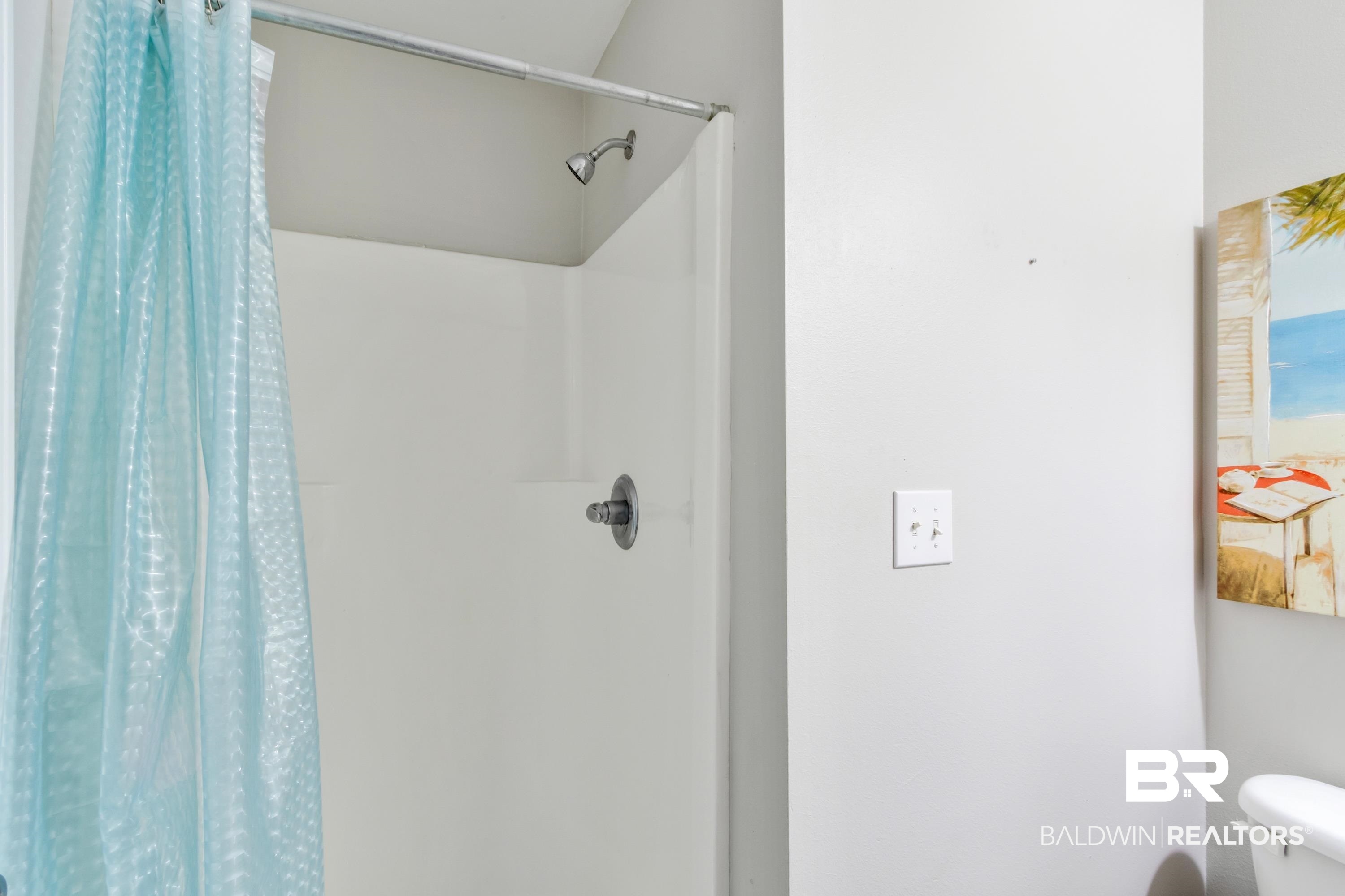 25957 Canal Road, Unit 208 Orange Beach, AL 36561 - Photo 20 of 28 White shower stall with a chrome shower head and temperature control