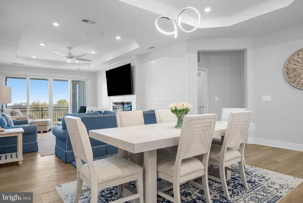 a living room with furniture and a view of kitchen