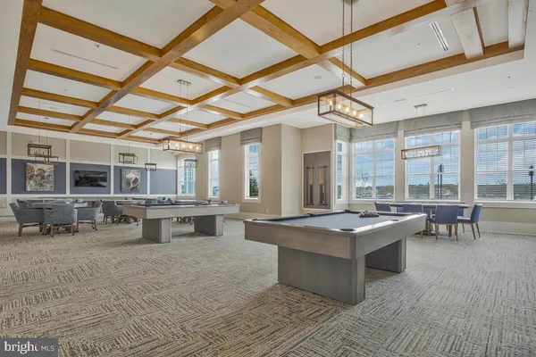 a dining room with furniture a rug and a large window