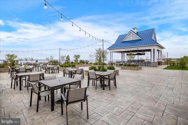 a view of a swimming pool with outdoor seating