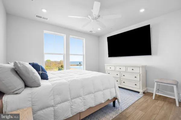 a bedroom with a large bed and a flat screen tv
