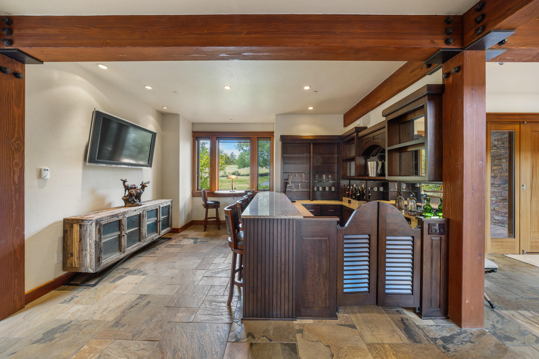 18883 Sutherland Court Bend, OR 97702 - Photo 19 of 70 A custom cherry bar with seating for four?crafted for conversation, celebration, and Central Oregon hospitality.