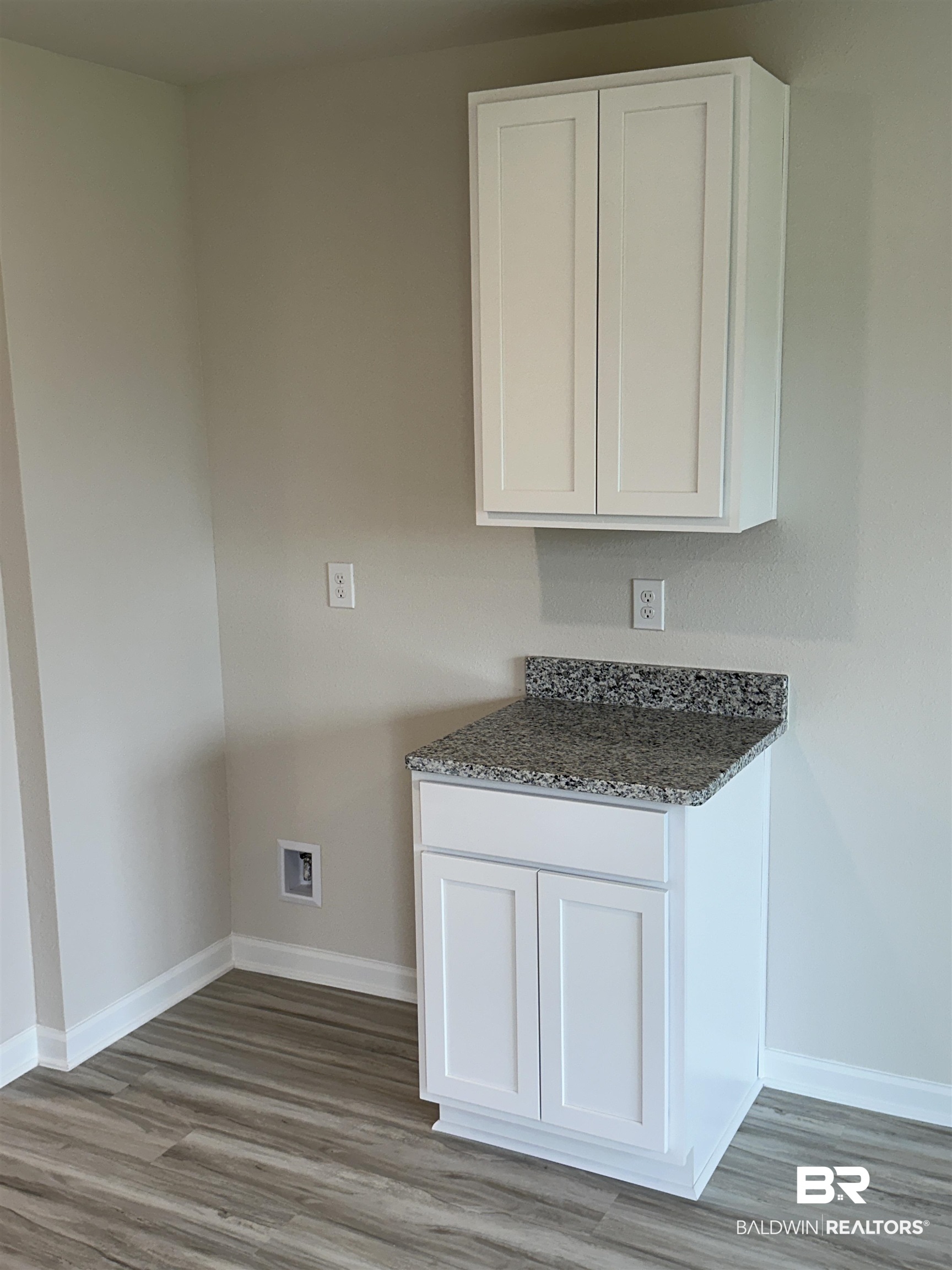 8850 Sea Star Circle Foley, AL 36535 - Photo 21 of 29 Laundry area featuring light wood-type flooring, cabinets, and washer hookup