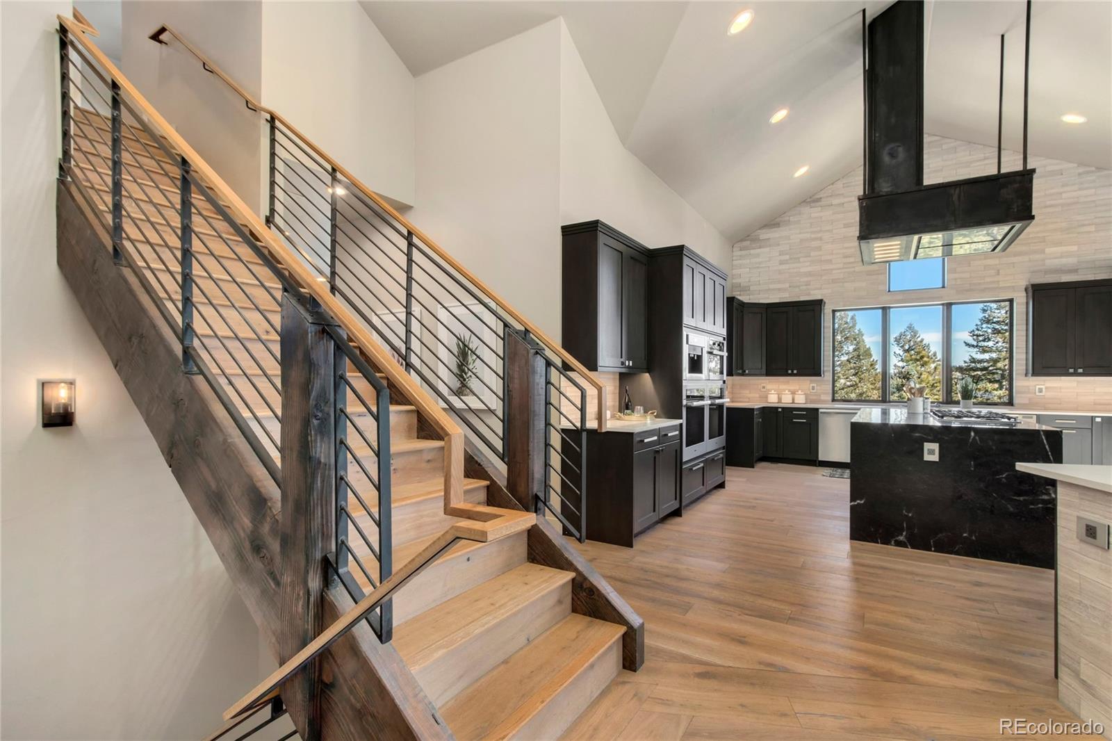 6135 Northway Drive Morrison, CO 80465 - Photo 15 of 40 a view of entryway and hall with wooden floor