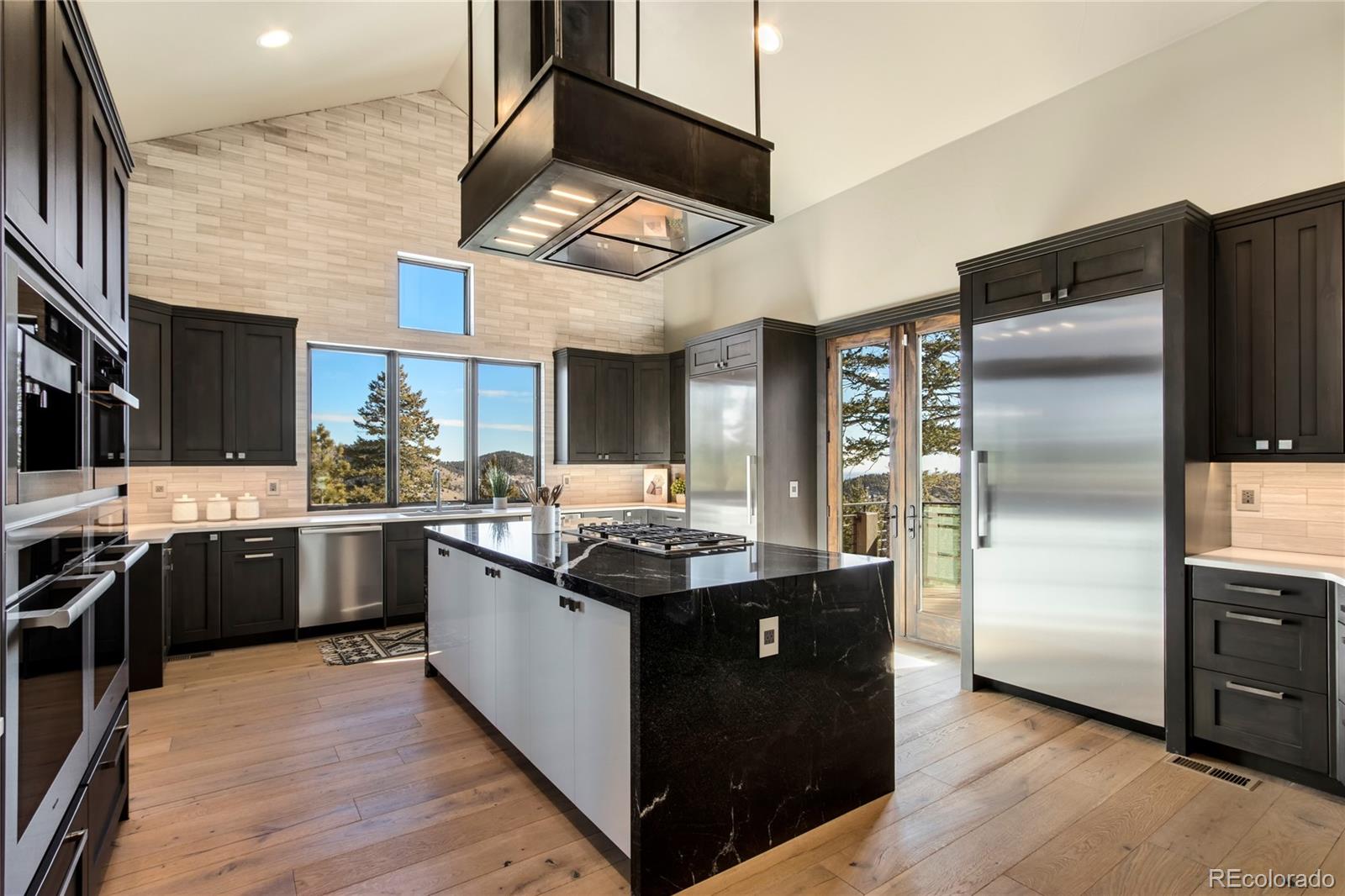 6135 Northway Drive Morrison, CO 80465 - Photo 17 of 40 a kitchen with stainless steel appliances granite countertop a stove and a refrigerator