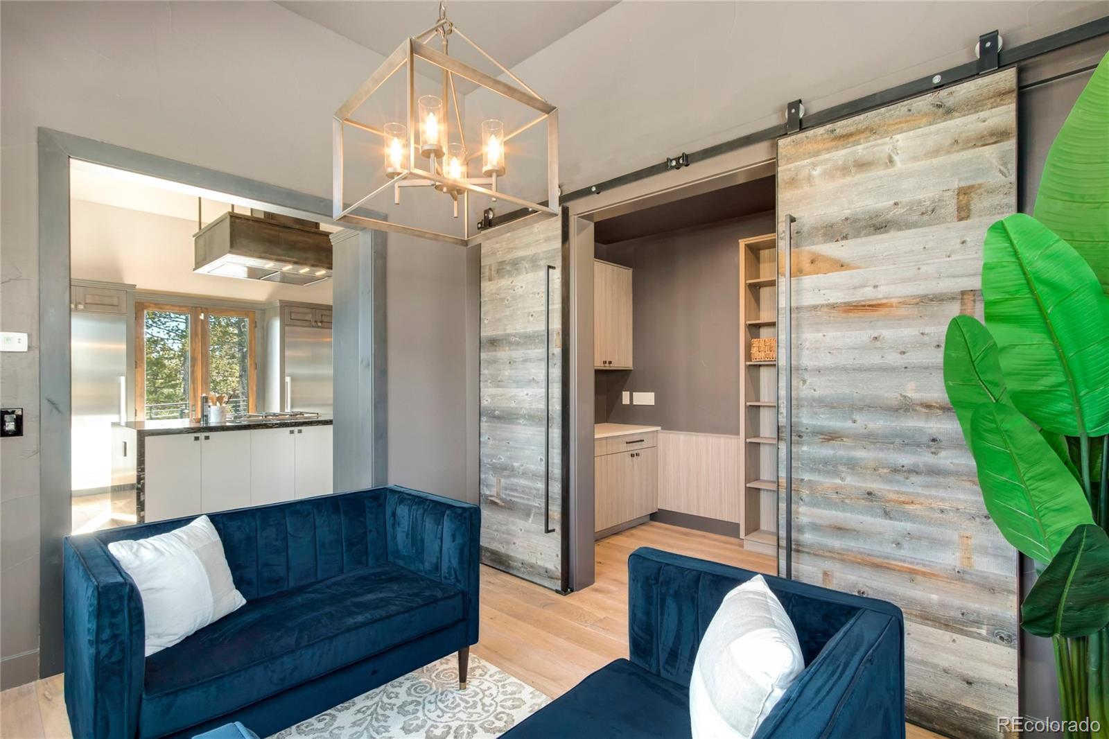 6135 Northway Drive Morrison, CO 80465 - Photo 20 of 40 a living room with furniture and a chandelier