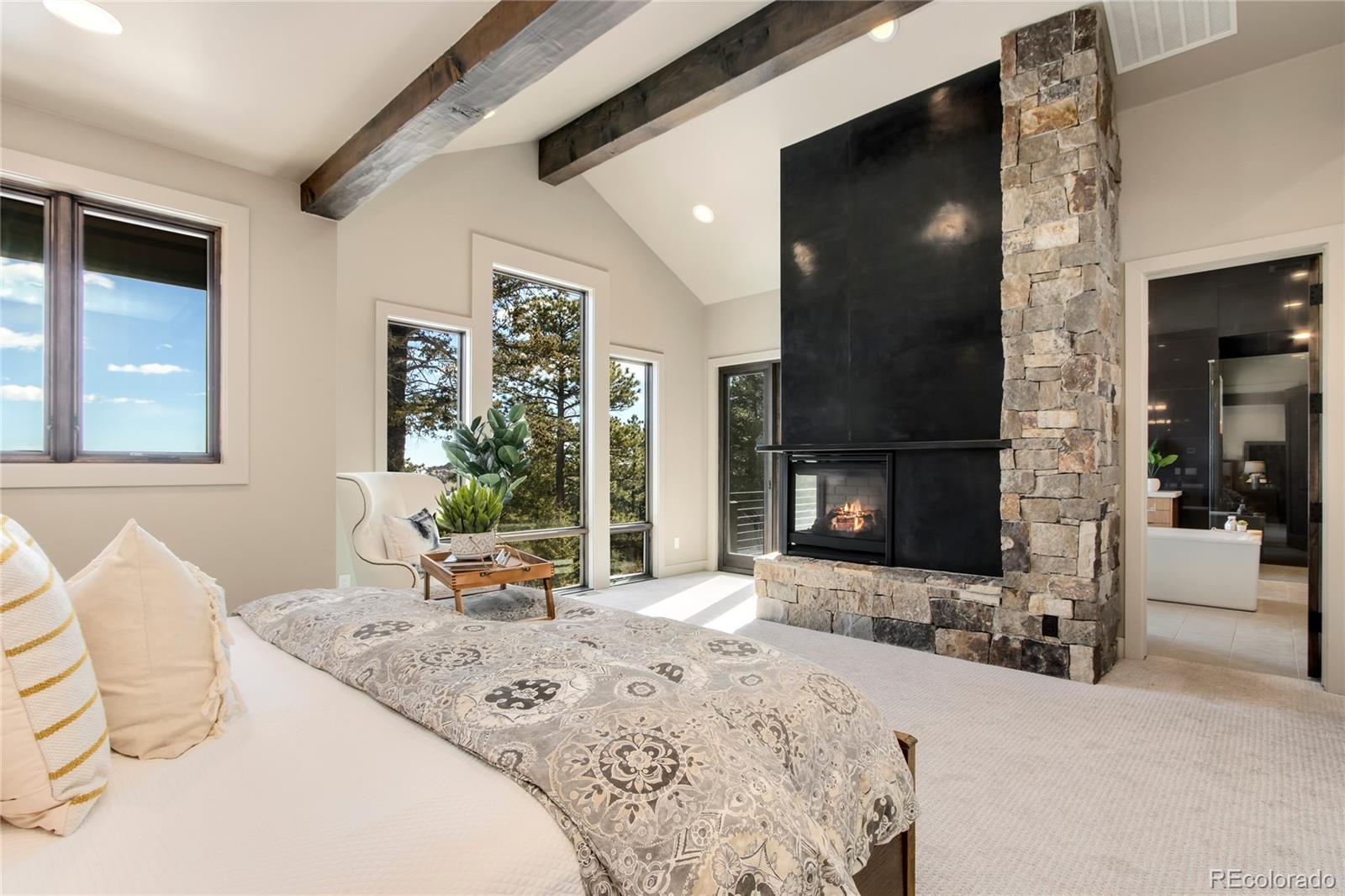 6135 Northway Drive Morrison, CO 80465 - Photo 24 of 40 a bedroom with furniture and a fireplace