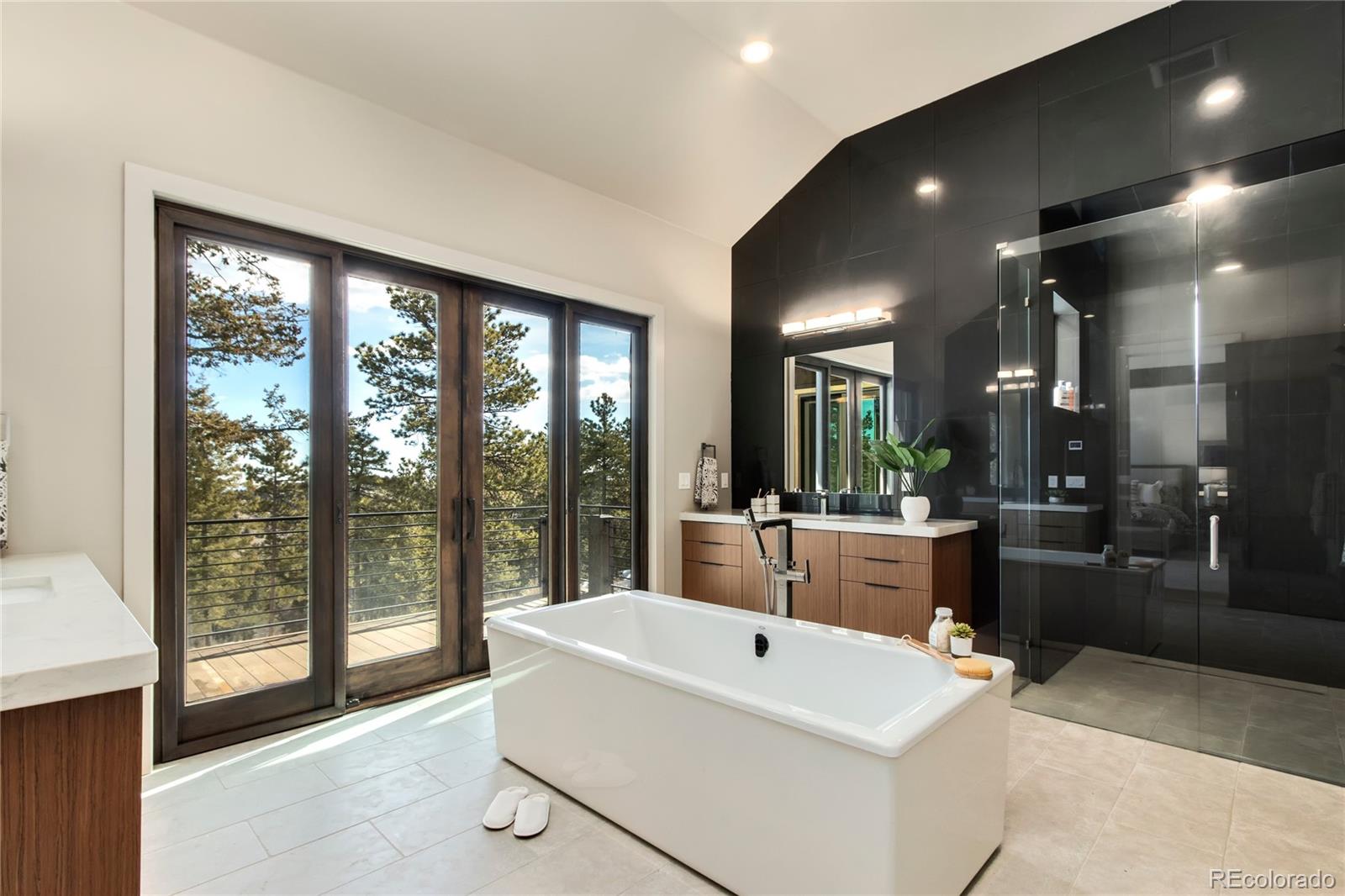 6135 Northway Drive Morrison, CO 80465 - Photo 26 of 40 a large white kitchen with large windows and refrigerator