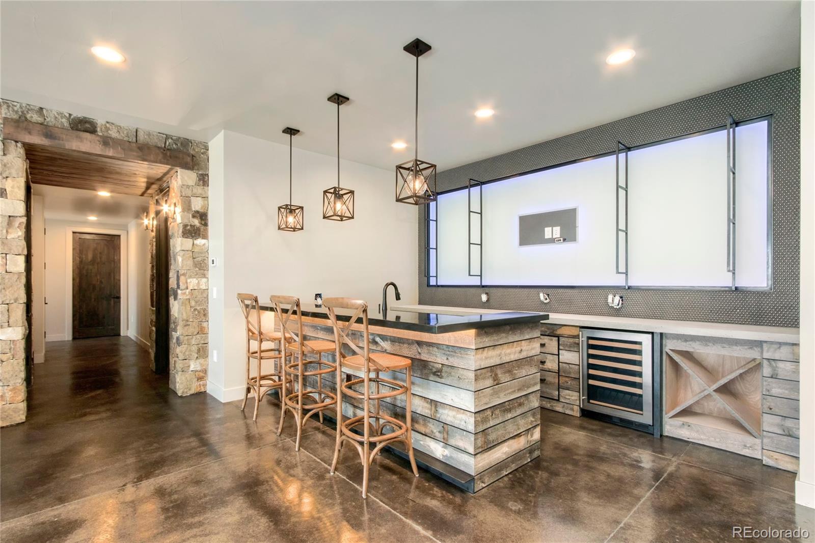 6135 Northway Drive Morrison, CO 80465 - Photo 29 of 40 a kitchen with kitchen island a large counter top space appliances and cabinets