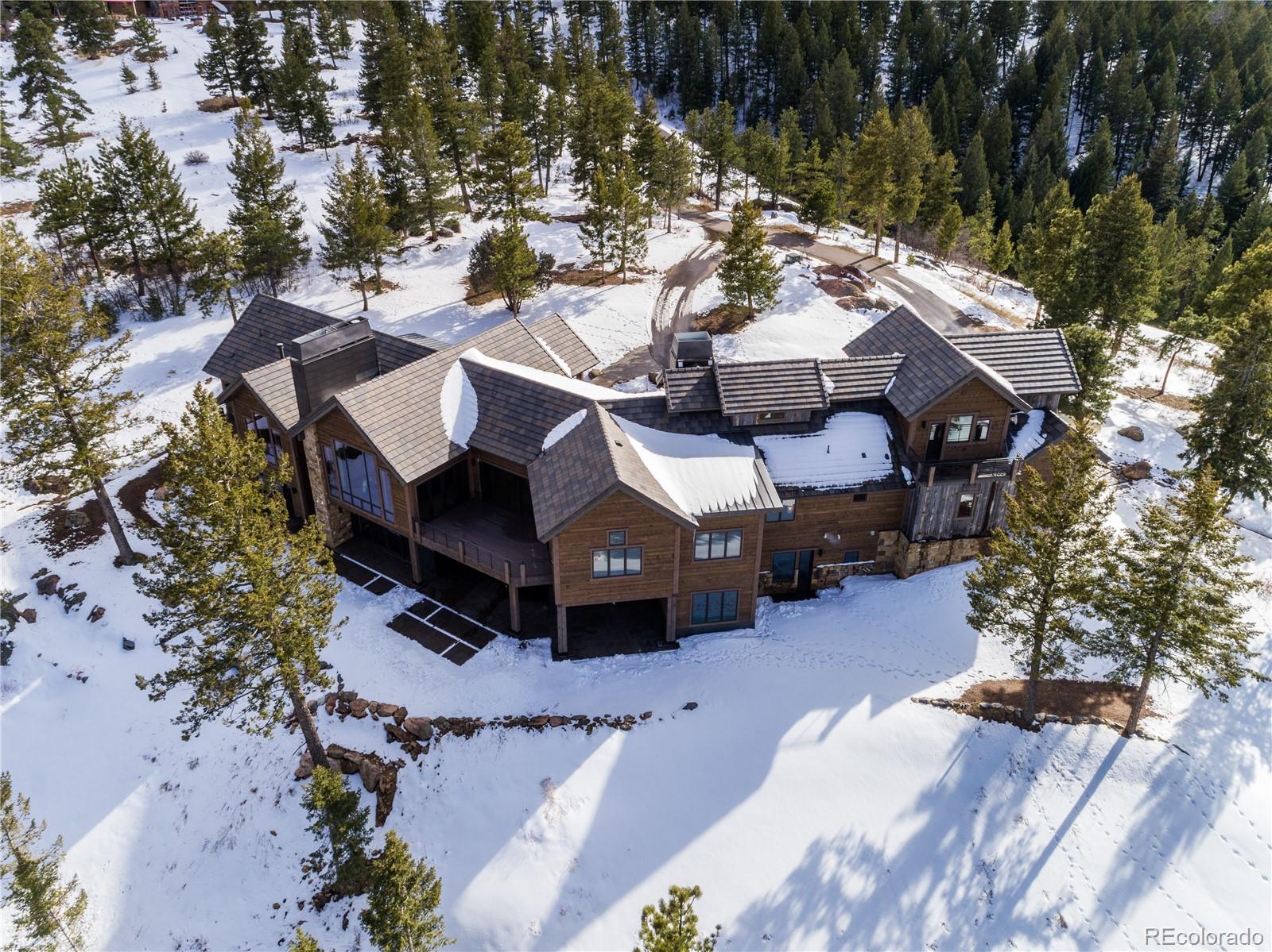 6135 Northway Drive Morrison, CO 80465 - Photo 6 of 40 a view of a house with a yard covered in snow