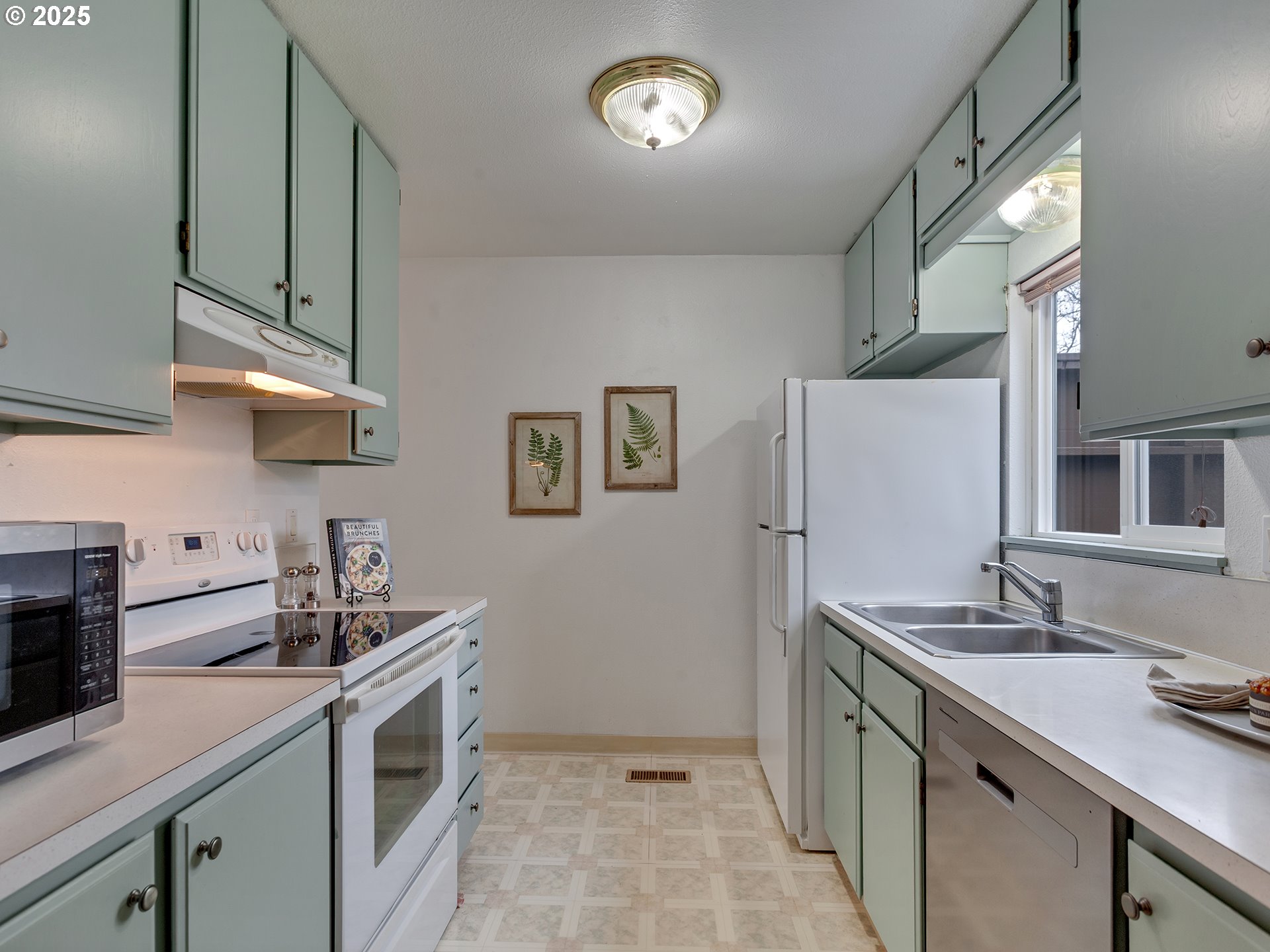 17822 Northwest Lakeway Court Beaverton, OR 97006 - Photo 19 of 45 a kitchen with a sink cabinets and stainless steel appliances