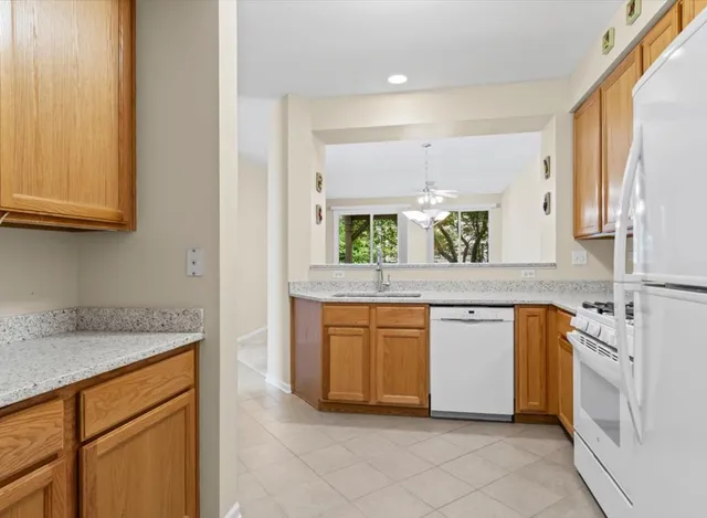 a kitchen with stainless steel appliances granite countertop a sink and a stove