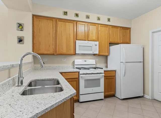 a kitchen with appliances a sink and a counter top space