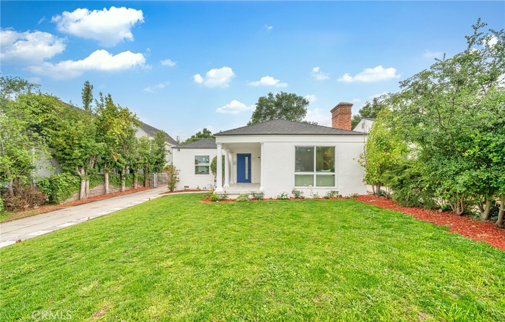 a front view of a house with a garden