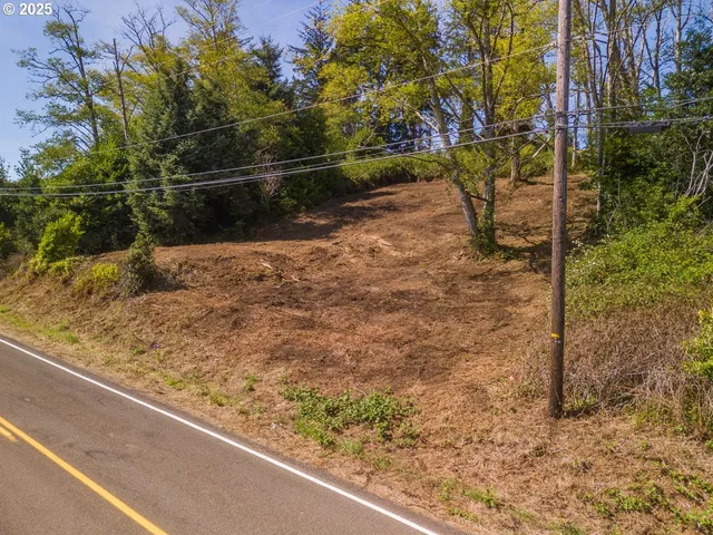 a view of a wooden fence with a yard