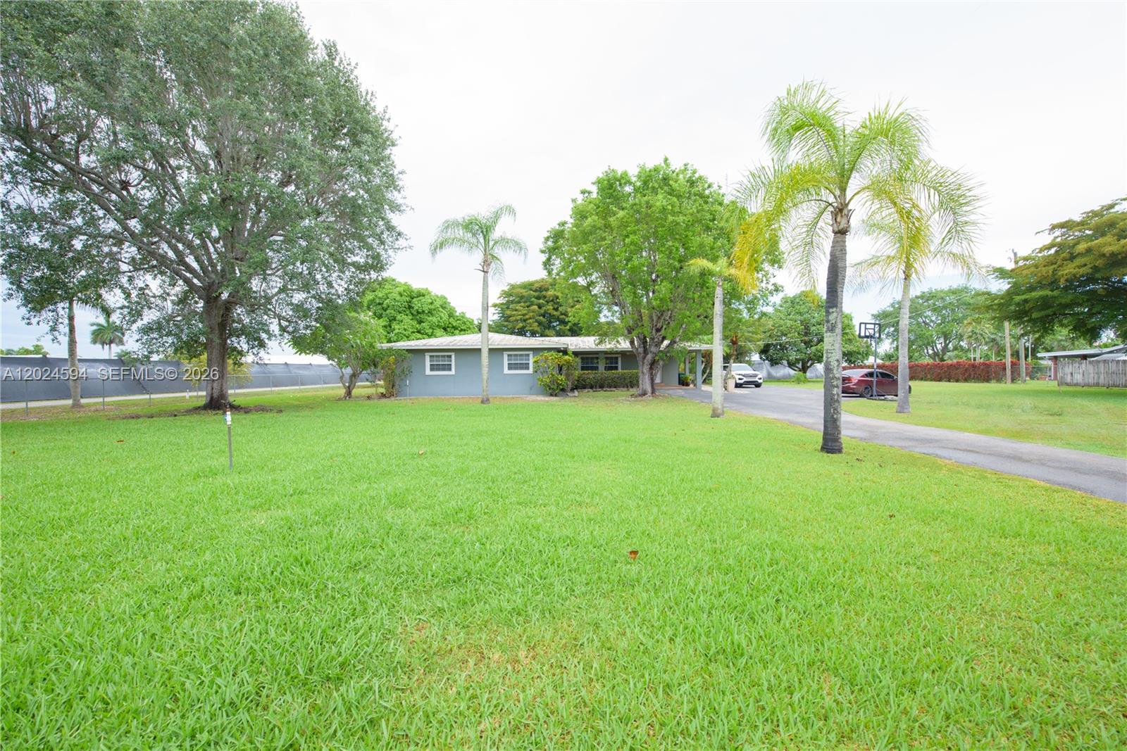 17355 Southwest 256th Street Homestead, FL 33031 - Photo 3 of 32 a view of a park with swings and slides