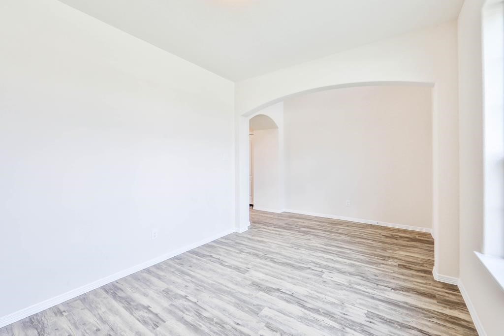 247 Sintra Lk Way Rosenberg, TX 77469 - Photo 4 of 28 a view of an empty room with wooden floor