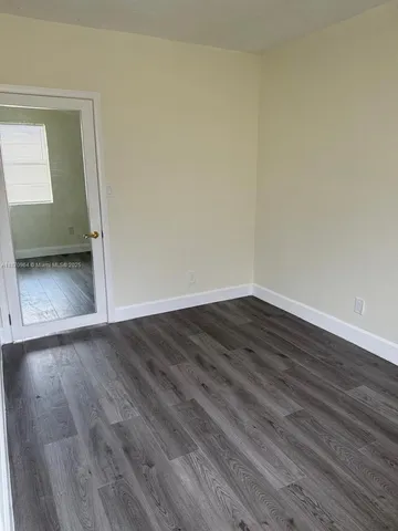 a kitchen with stainless steel appliances wooden cabinets and wooden floor