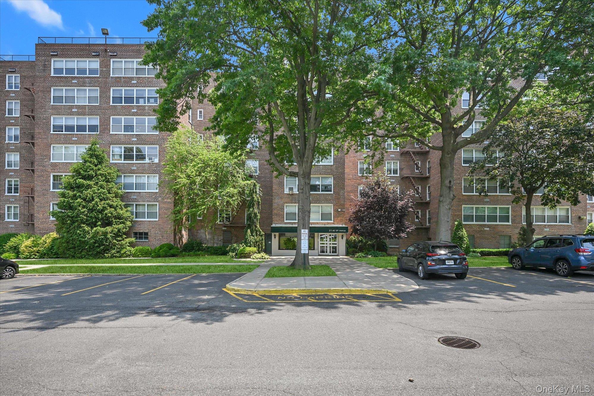 211-40 18th Avenue, Unit 4A Queens, NY 11360 - Photo 1 of 21 a view of a parked cars in front of a building