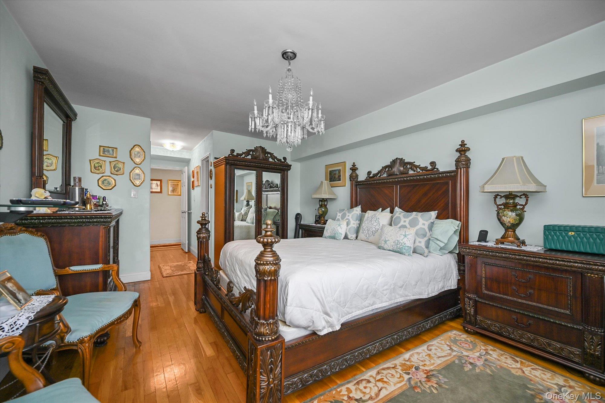 211-40 18th Avenue, Unit 4A Queens, NY 11360 - Photo 10 of 21 a bedroom with bed and wooden floor