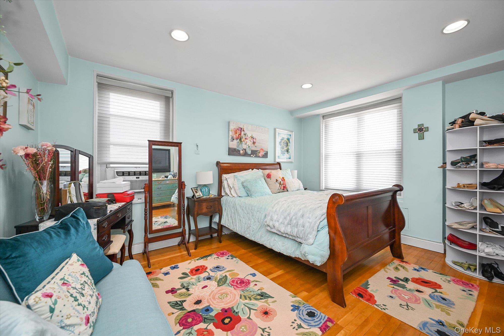 211-40 18th Avenue, Unit 4A Queens, NY 11360 - Photo 11 of 21 a bedroom with furniture and a book shelf