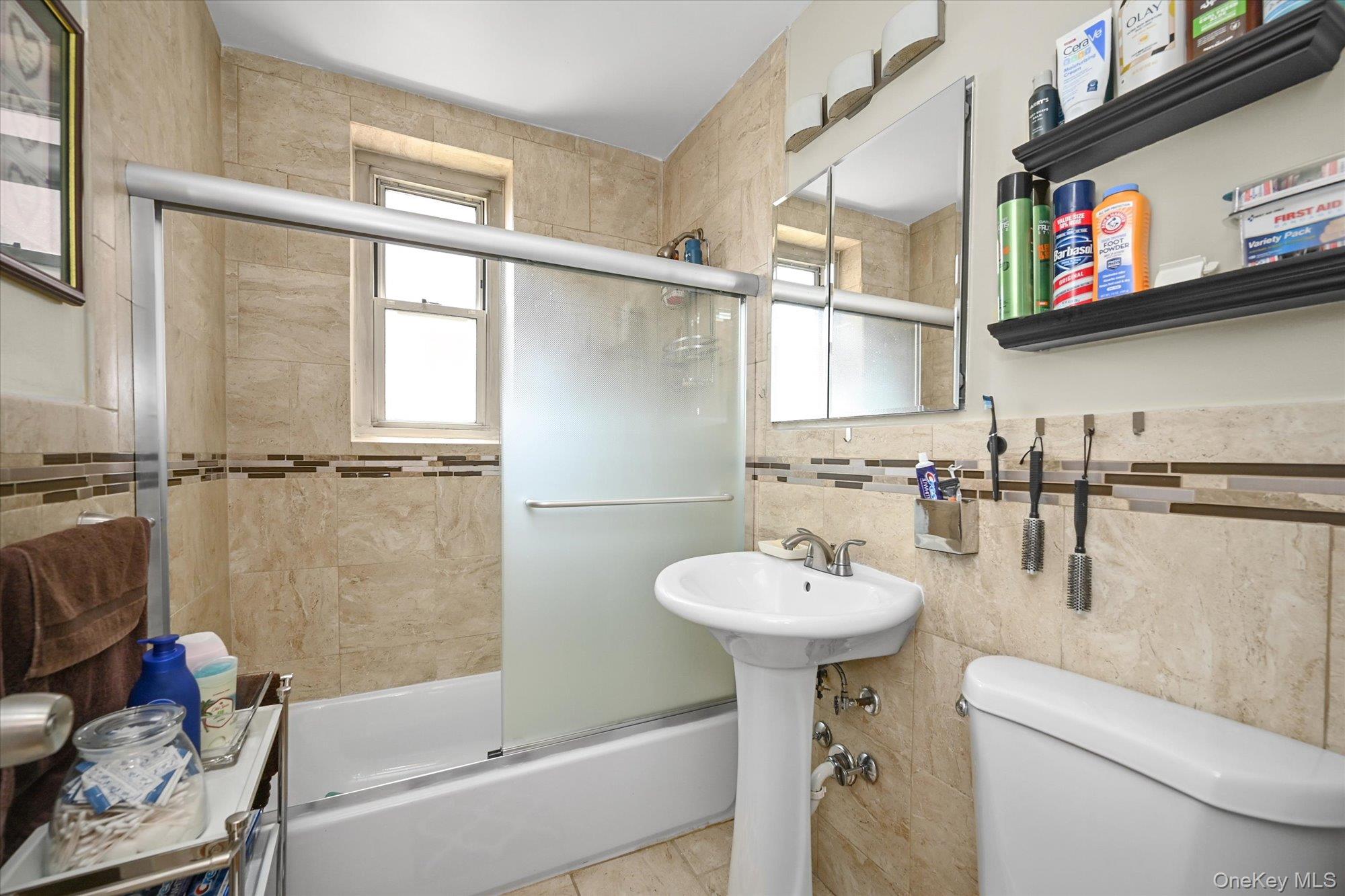 211-40 18th Avenue, Unit 4A Queens, NY 11360 - Photo 14 of 21 a bathroom with a sink toilet and shower