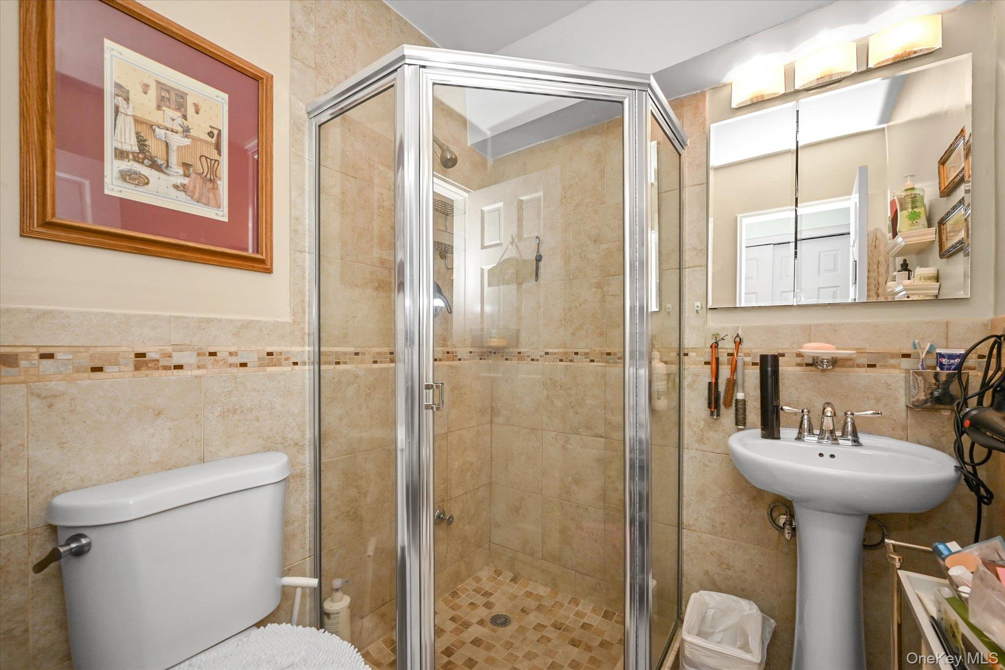 211-40 18th Avenue, Unit 4A Queens, NY 11360 - Photo 15 of 21 a bathroom with a sink toilet and shower