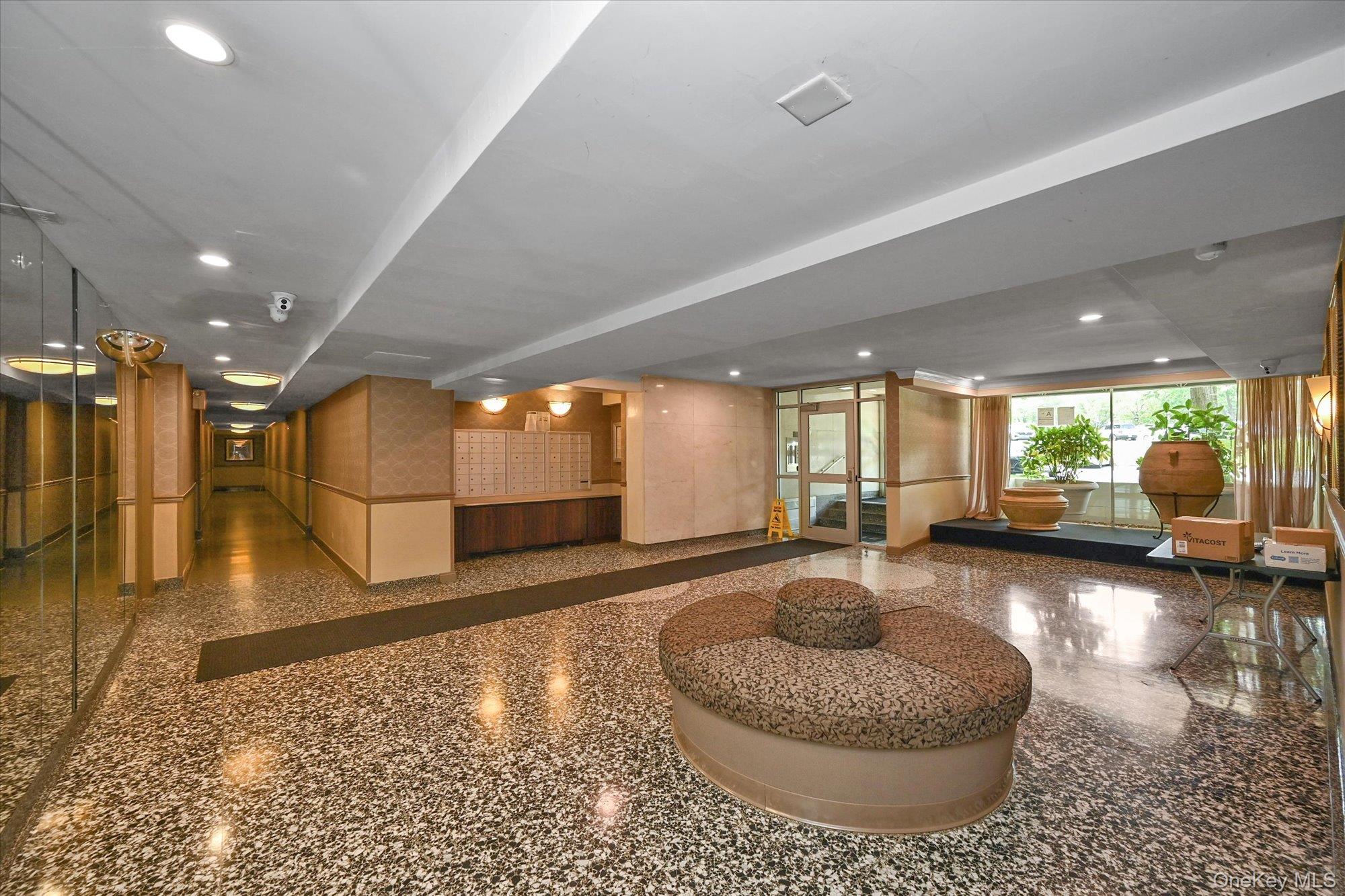 211-40 18th Avenue, Unit 4A Queens, NY 11360 - Photo 16 of 21 a living room with furniture and a wooden floor
