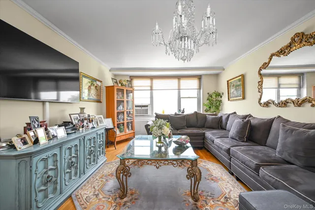 a living room with furniture and a chandelier