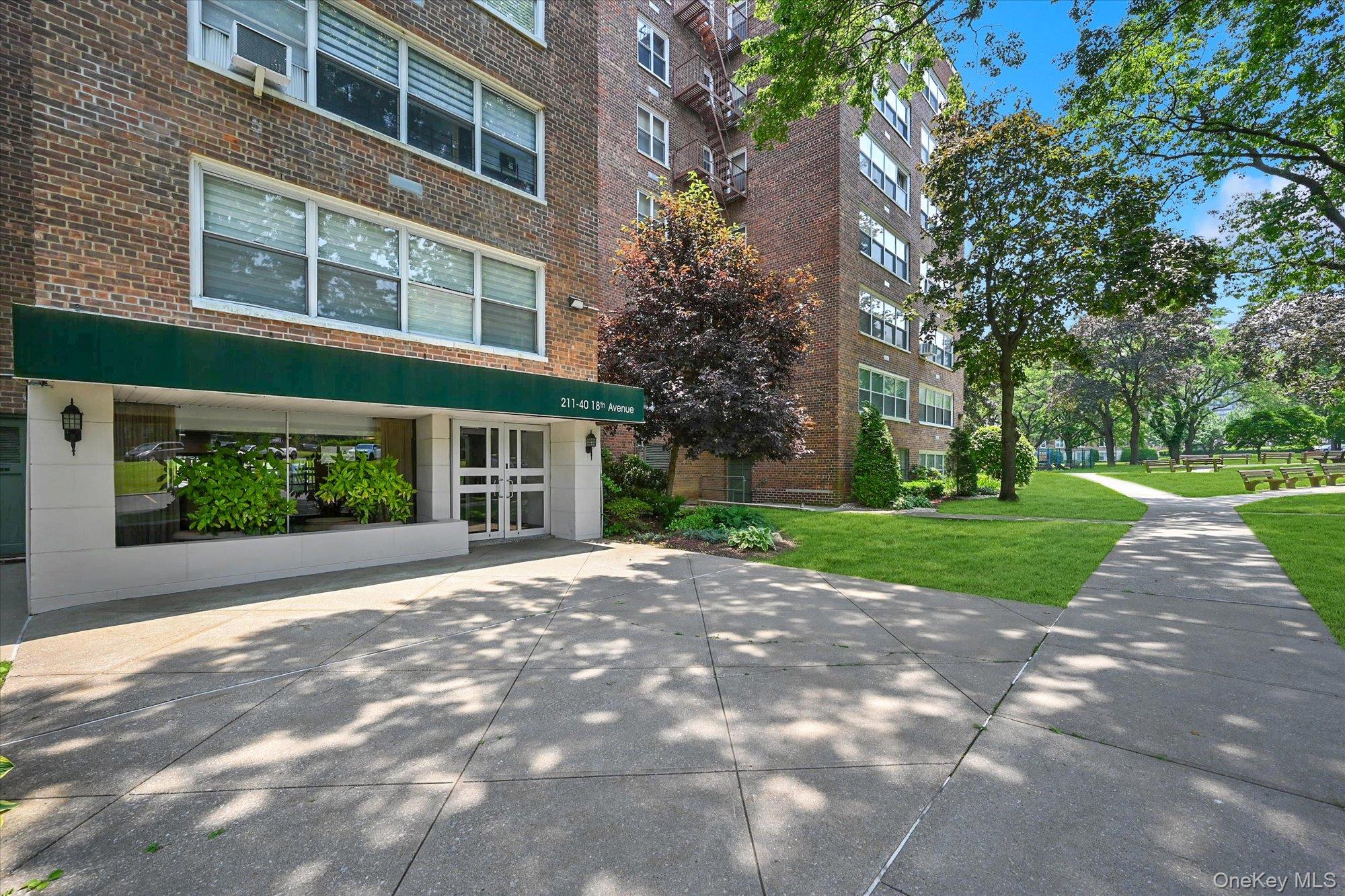 211-40 18th Avenue, Unit 4A Queens, NY 11360 - Photo 20 of 21 a view of a house with a yard