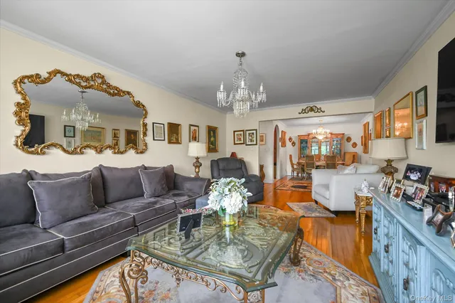 a living room with furniture and a chandelier