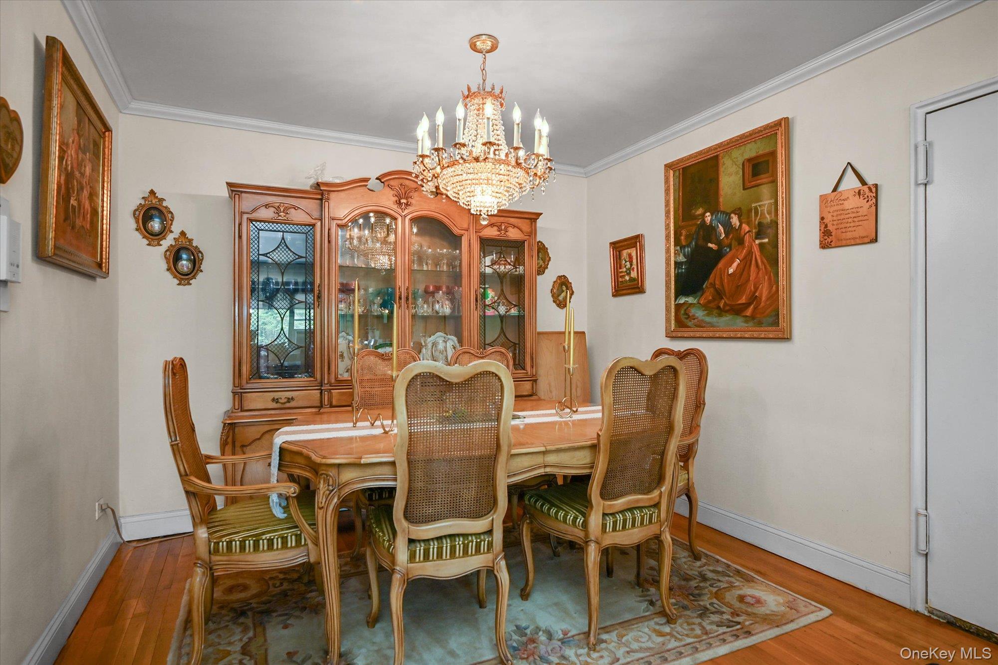 211-40 18th Avenue, Unit 4A Queens, NY 11360 - Photo 6 of 21 a dining room with furniture a chandelier and wooden floor