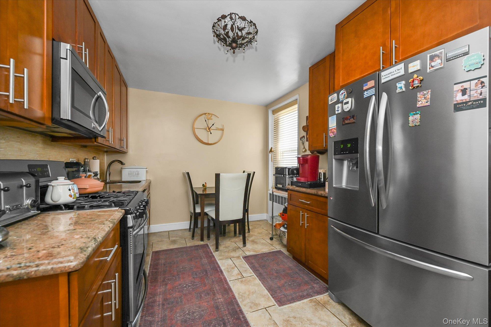 211-40 18th Avenue, Unit 4A Queens, NY 11360 - Photo 7 of 21 a kitchen with stainless steel appliances granite countertop a refrigerator a stove and a sink