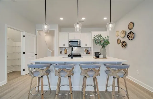 a kitchen with granite countertop a table and chairs in it