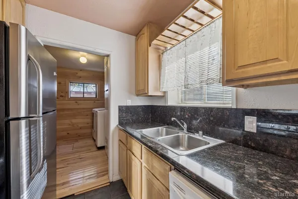 a kitchen that has a sink and cabinets