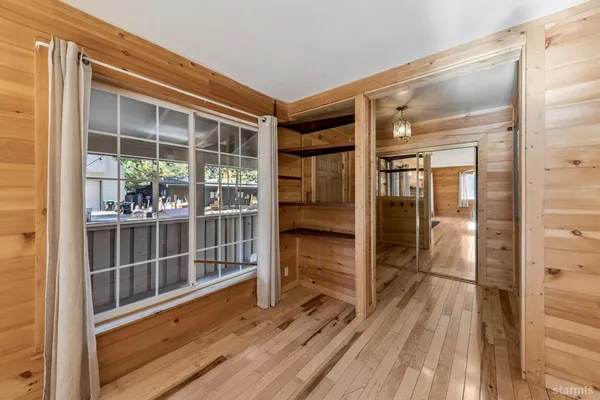 a view of a balcony with wooden floor and door